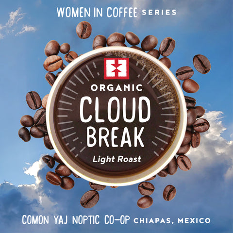 Cup of brewed coffee with text overlayed that says 'Cloud Break' with coffee beans and a blue sky background
