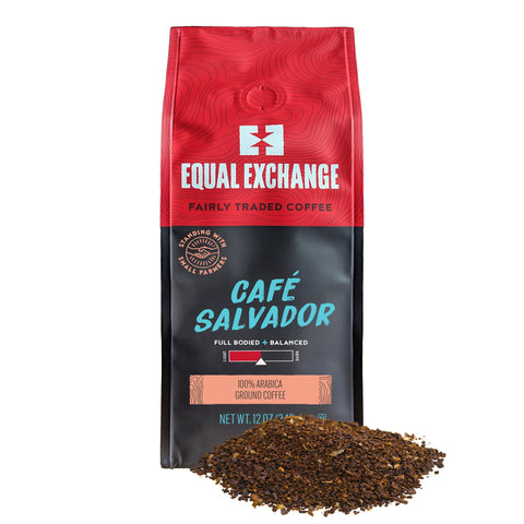 red and black coffee bag of Cafe Salvador with pile of ground coffee