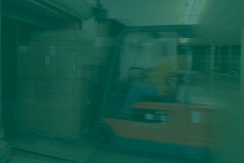 Forklift moving boxes in an Equal Exchange warehouse 