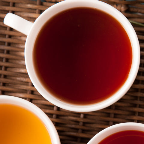 cup of brewed English Breakfast tea on a wicker mat