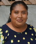 Nilka Sanchez, member of COCABO co-op in Panama, in front of a cement wall