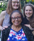 Miguelina Santos of CONACADO cacao co-op stands with Equal Exchange's Laura Bechard and Kate Chess on a trip to the Dominican Republic