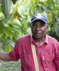 Komla Gagna Ekpete of SCOOPS IKPA co-op standing on cacao farm in Togo