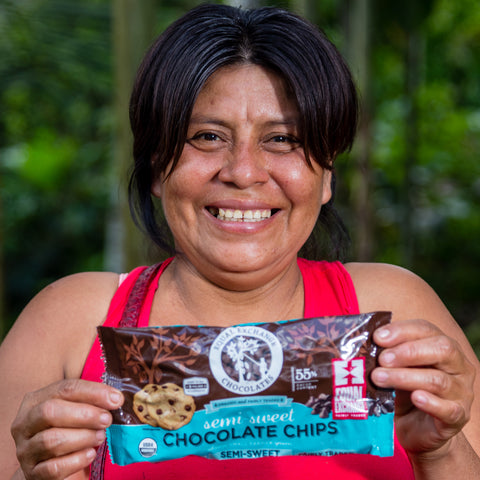 Joisy Tuanama Lumba of ACOPAGRO co-op holding a bag of Equal Exchange semi-sweet chocolate chips 