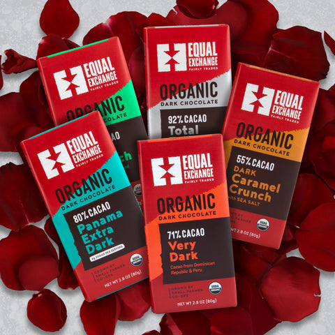 five Equal Exchange chocolate bars on top of red rose petals