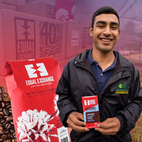 Man holding Equal Exchange chocolate bar in front of 40th Anniversary boxes