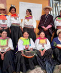 Women farmers of Norandino with baskets of unroasted coffee beans in traditional dress