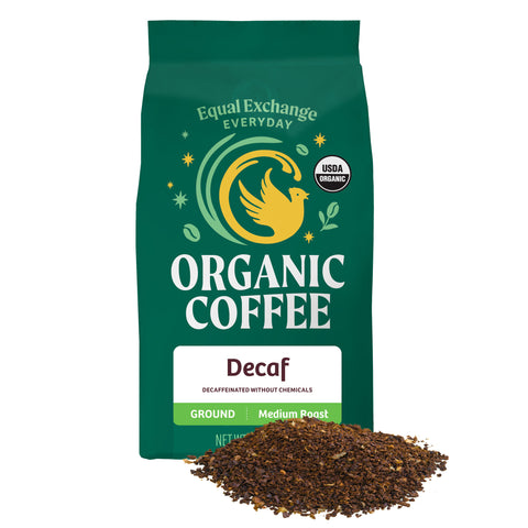 Green bag of Equal Exchange Everyday Organic Coffee Decaf with a pile of ground coffee