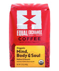 A 12 oz bag of Equal Exchange Coffee 'Organic Mind, Body & Soul' medium/vienna roast blend. The packaging is bright red with a white logo and a yellow label at the bottom.