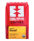 A 12 oz bag of Equal Exchange Organic Decaf Coffee, featuring a bright red bag with a white logo and a yellow label at the bottom.