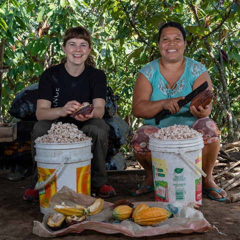 Laura Bechard of Equal Exchange with Orfith Satalaya Tapullima of Oro Verde co-op together removing cacao beans from the pods