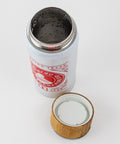 Top down view of open insulated steel tumbler with bamboo and plastic cap