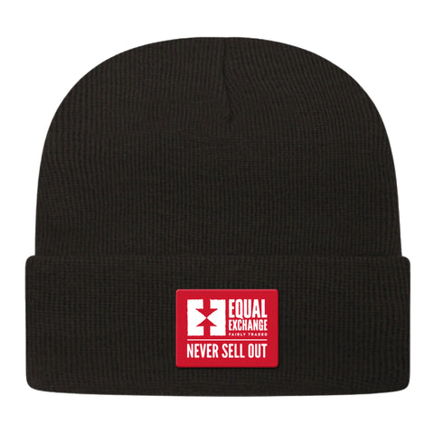 black knit beanie cap with red and white Equal Exchange Never Sell Out patch stitched on the front