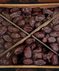 bulk box filled with fresh, plump medjool dates neatly arranged with cardboard dividers