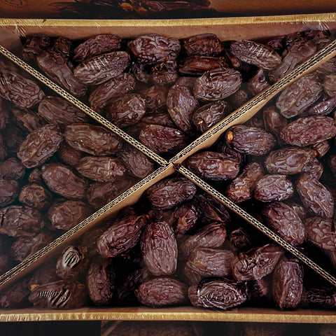 bulk box filled with fresh, plump medjool dates neatly arranged with cardboard dividers