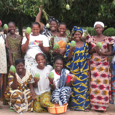 Group of women mango farmers holding green mangoes, Burkina Faso