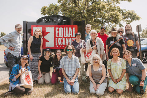 Group of citizen consumers in front of Equal Exchange sign in West Bridgewater Massachusetts