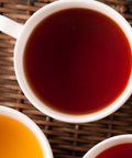 cup of brewed English Breakfast tea on a wicker mat