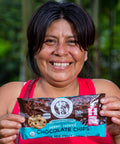 Joisy Tuanama Lumba of ACOPAGRO co-op holding a bag of Equal Exchange semi-sweet chocolate chips 