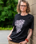 Woman wearing a black T-shirt with 'Power to the Farmers' written on it