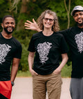 Three people each wearing a black T-shirt with 'Power to the Farmers' written on it