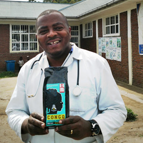 Dr. Bwema of Panzi Hospital holding a bag of Congo Coffee